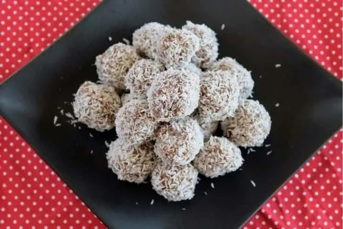 Coconut balls on a plate, perfect as edible Christmas gifts adorned with a polka dot pattern.