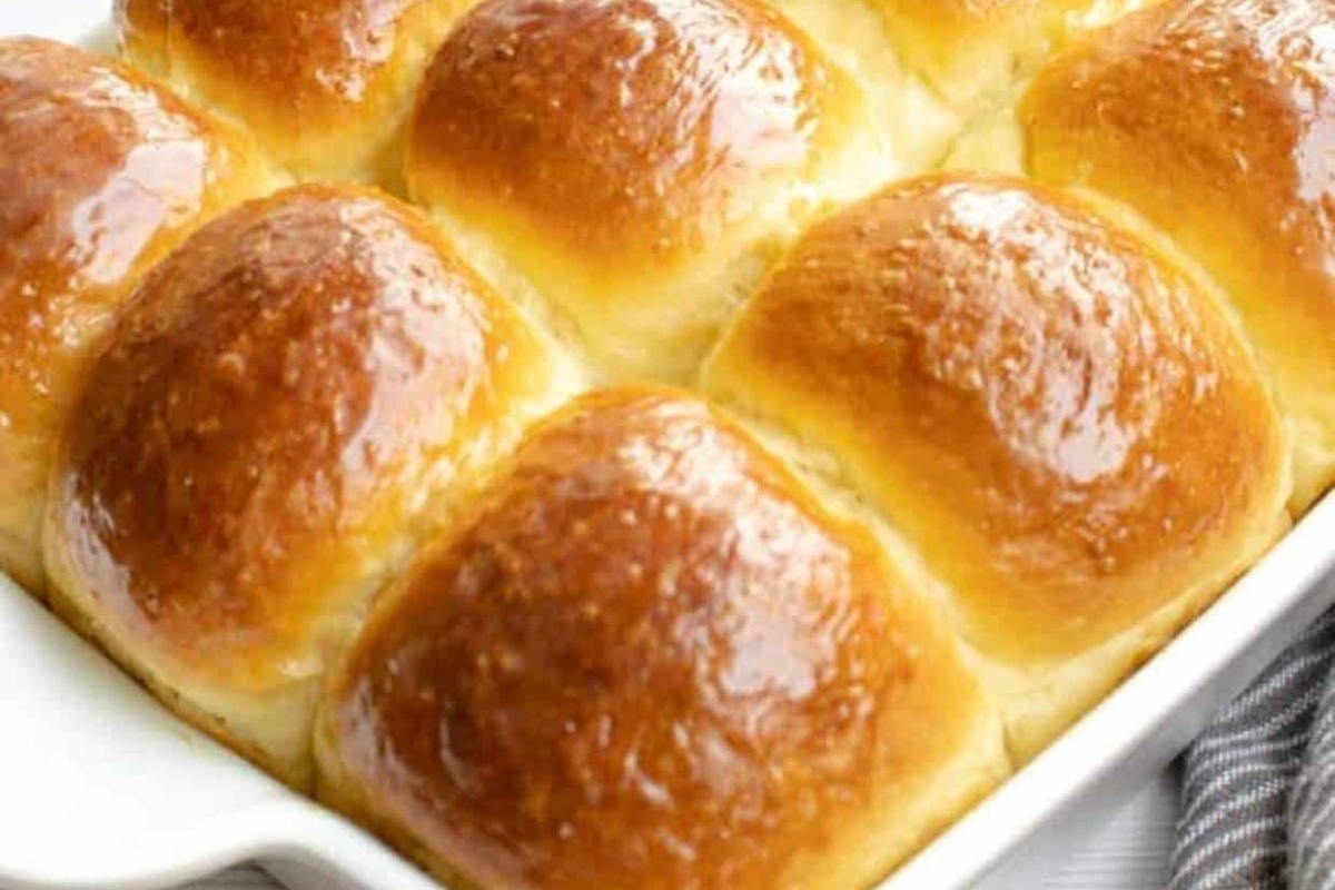 White baking dish filled with mouthwatering bread rolls.