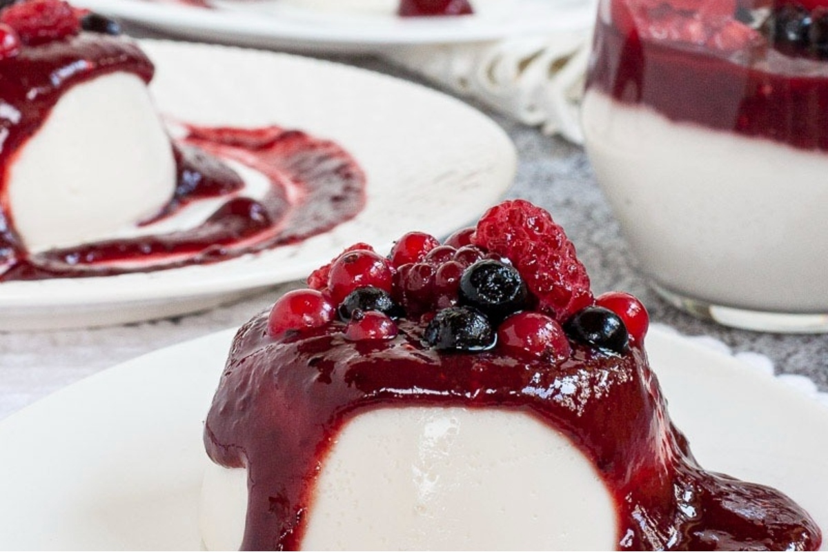 An Italian dessert with berries and cream on a plate.