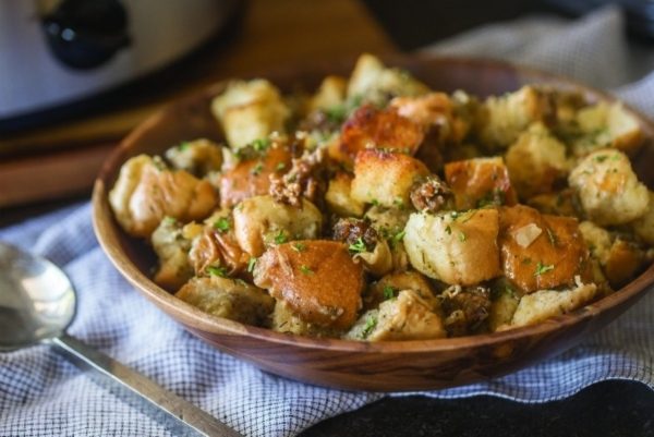 A cheap bowl of stuffing in front of a slow cooker.
