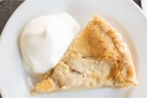 A slice of apple pie on a white plate.
