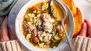 A classic bowl of 1950's soup with meatballs and vegetables.