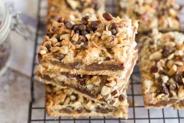A stack of chocolate chip cookie bars on a cooling rack.