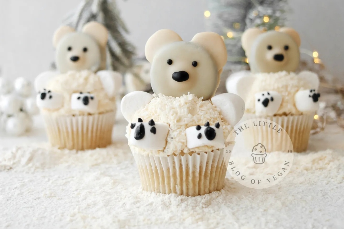 Three Christmas-themed cupcakes with polar bears on them.