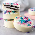 A recipe for white chocolate oreos with sprinkles on top.