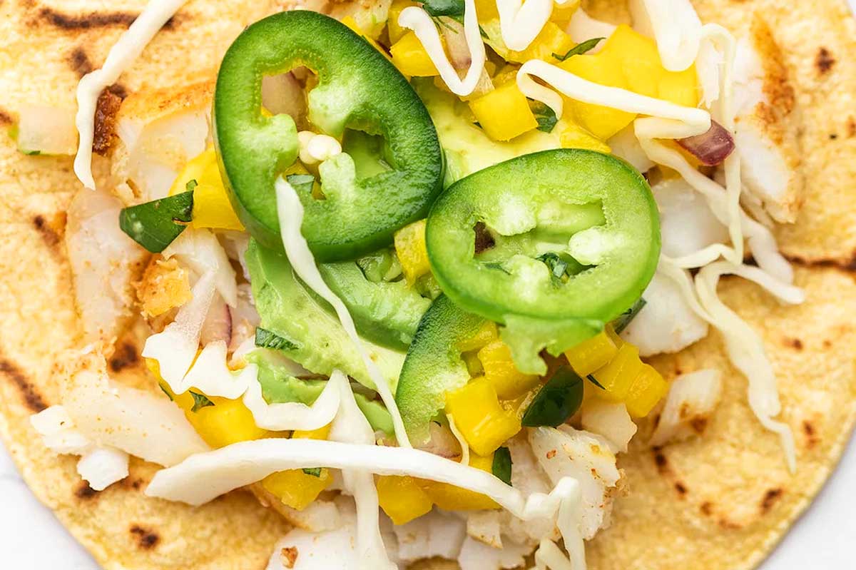 Fish tacos with mango and jalapenos.