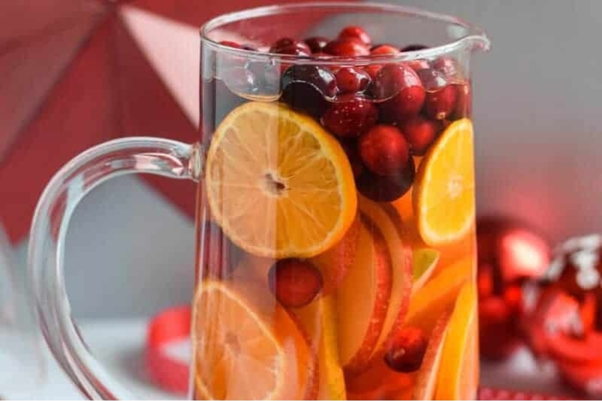 A festive pitcher of cranberry sangria with oranges and cranberries, perfect for Christmas cocktails.