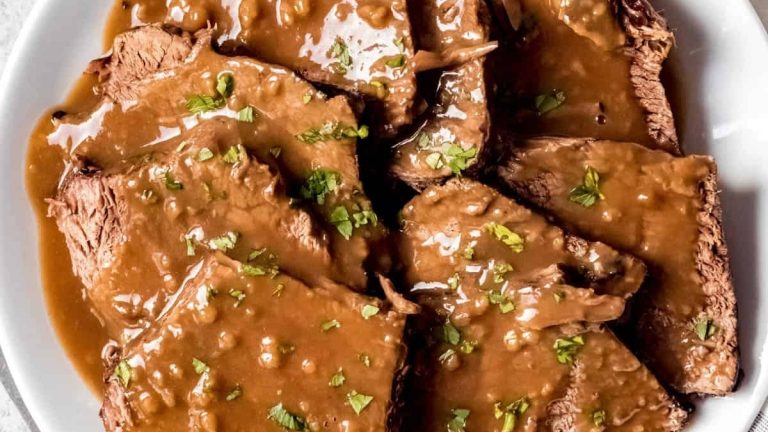 A German recipe featuring a plate of beef with rich gravy.