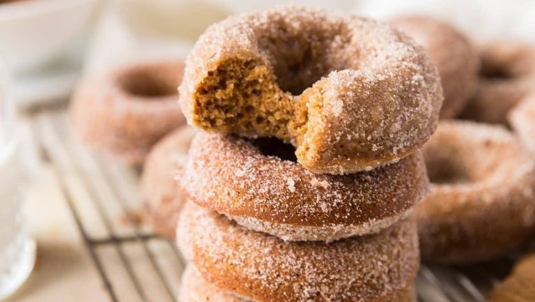 A stack of cinnamon sugar donuts on a cooling rack, perfect for those with a sweet tooth or looking to try out new flavored recipes.