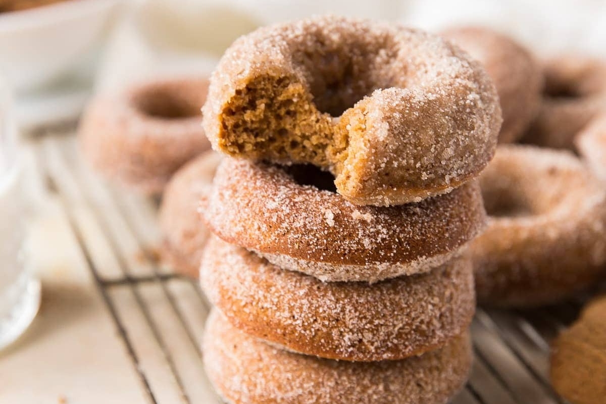 A stack of cinnamon sugar donuts on a cooling rack, perfect for those with a sweet tooth or looking to try out new flavored recipes.