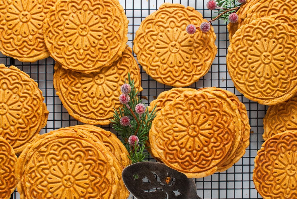 Chinese mooncakes on a cooling rack, complemented by an Italian dessert.