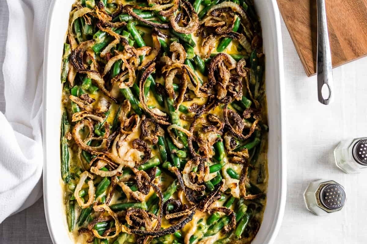A country-style casserole dish with green beans and onions, perfect for Thanksgiving.