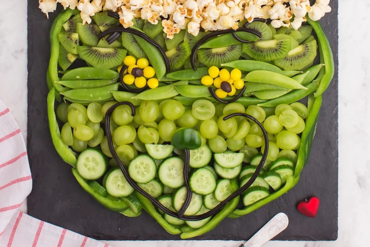 A plate of fruits and vegetables shaped like a teddy bear, perfect for healthy recipes or bringing a touch of the Grinch to your table.