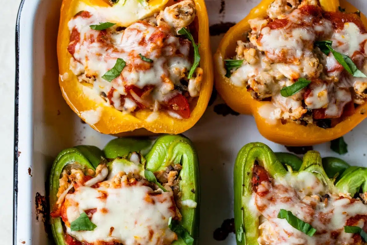 Ground turkey stuffed peppers in a baking dish.