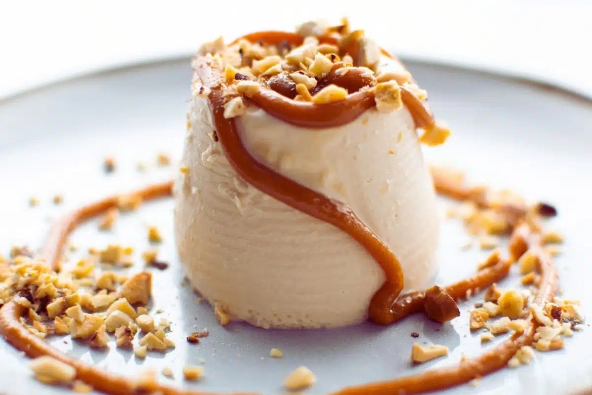 An Italian Dessert sundae topped with caramel and nuts.