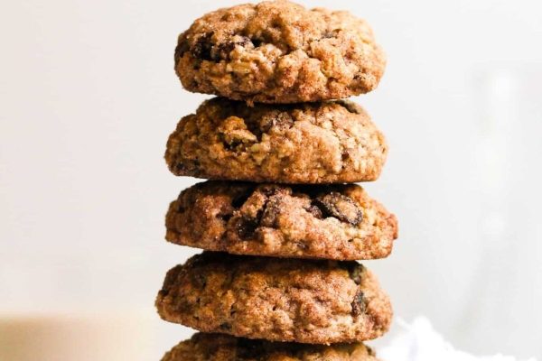 A stack of oatmeal cookies on a white plate.
