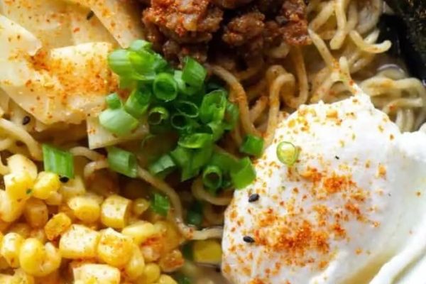 A delectable ramen recipe featuring a tantalizing bowl of noodle soup brimming with succulent meat and sweet corn.