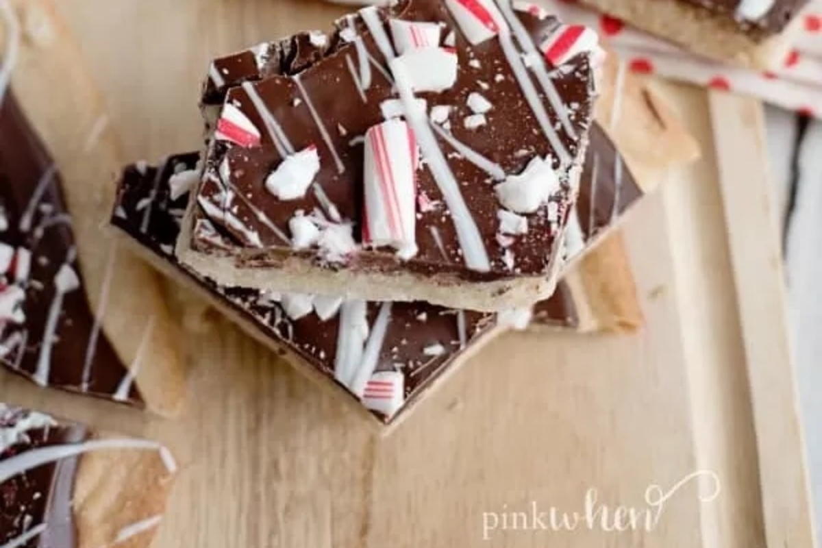 Christmas-inspired peppermint bark displayed on a cutting board.