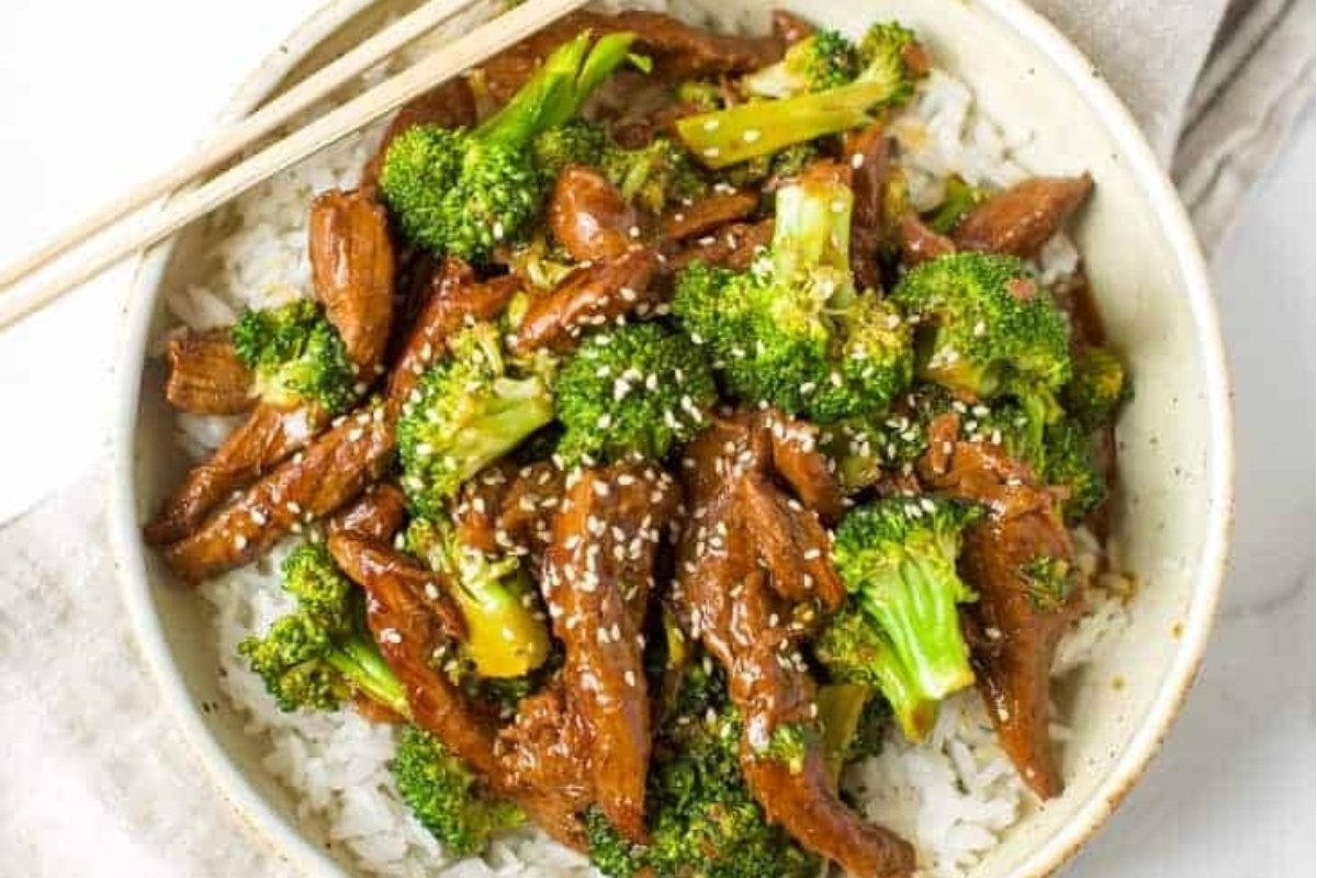 A bowl of beef and broccoli stir fry with chopsticks, perfect for picky eaters looking for a delicious and nutritious meal option.