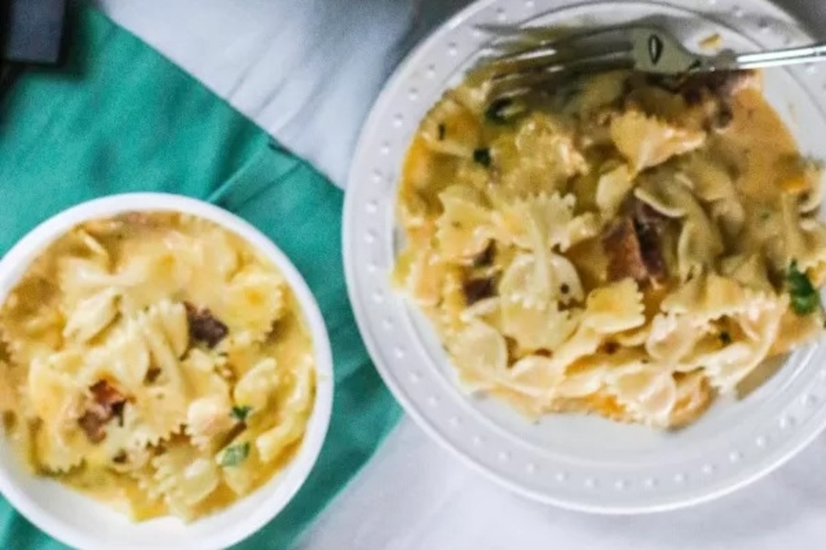 An Italian main dish of pasta served with a fork on a table.