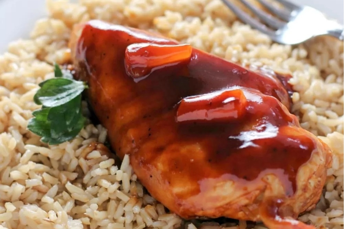 Hawaiian-inspired BBQ chicken with rice and sauce on a plate.