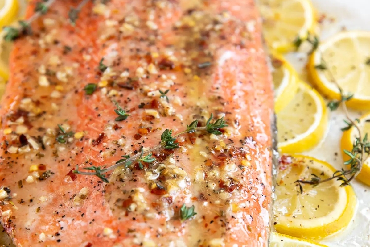 Salmon with lemons and thyme baked on a sheet.