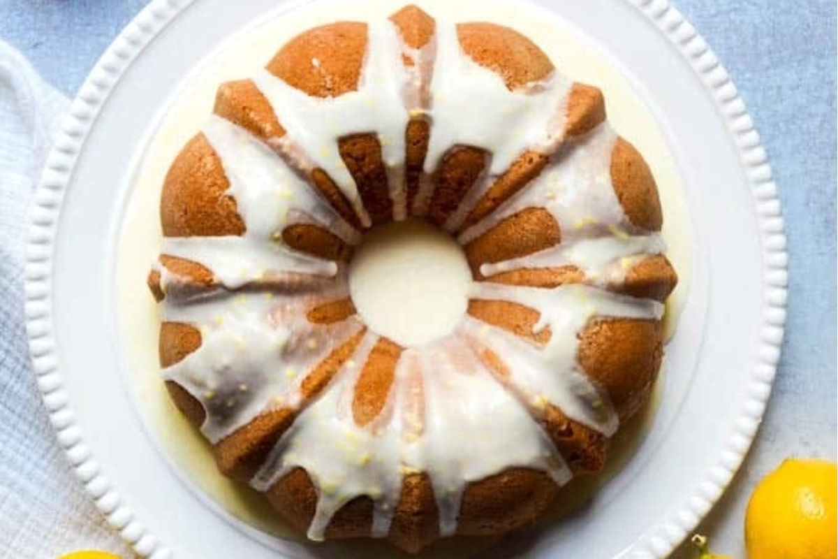 A plate with a lemon bundt cake and icing.