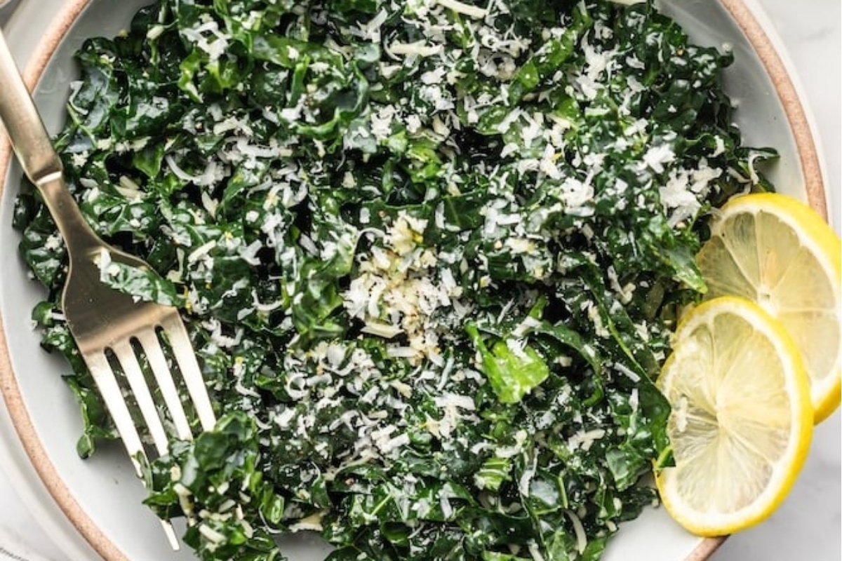 A refreshing bowl of kale salad with a zesty touch of lemon and a sprinkle of savory parmesan.