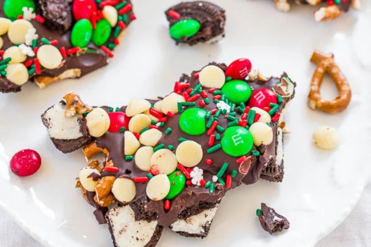 A festive Christmas bark adorned with an assortment of candy and pretzels.