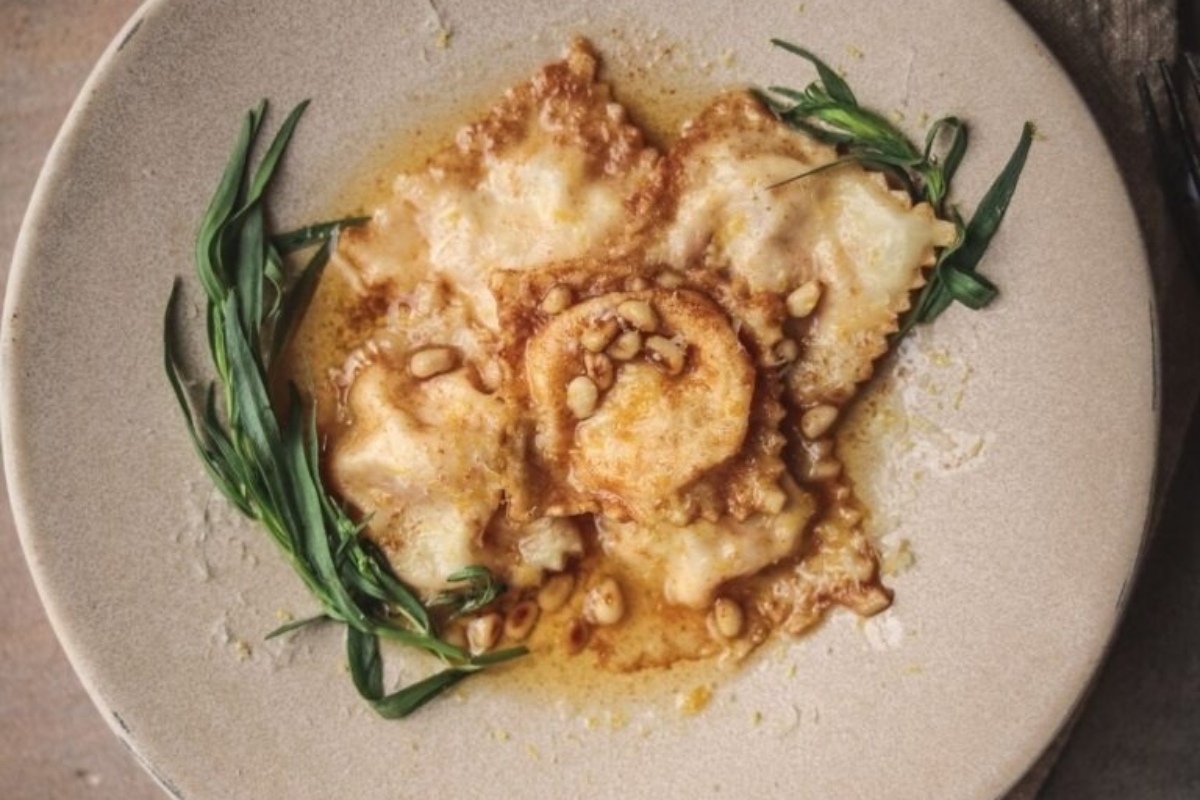 Italian main dish: Ravioli on a plate with sprigs of rosemary.