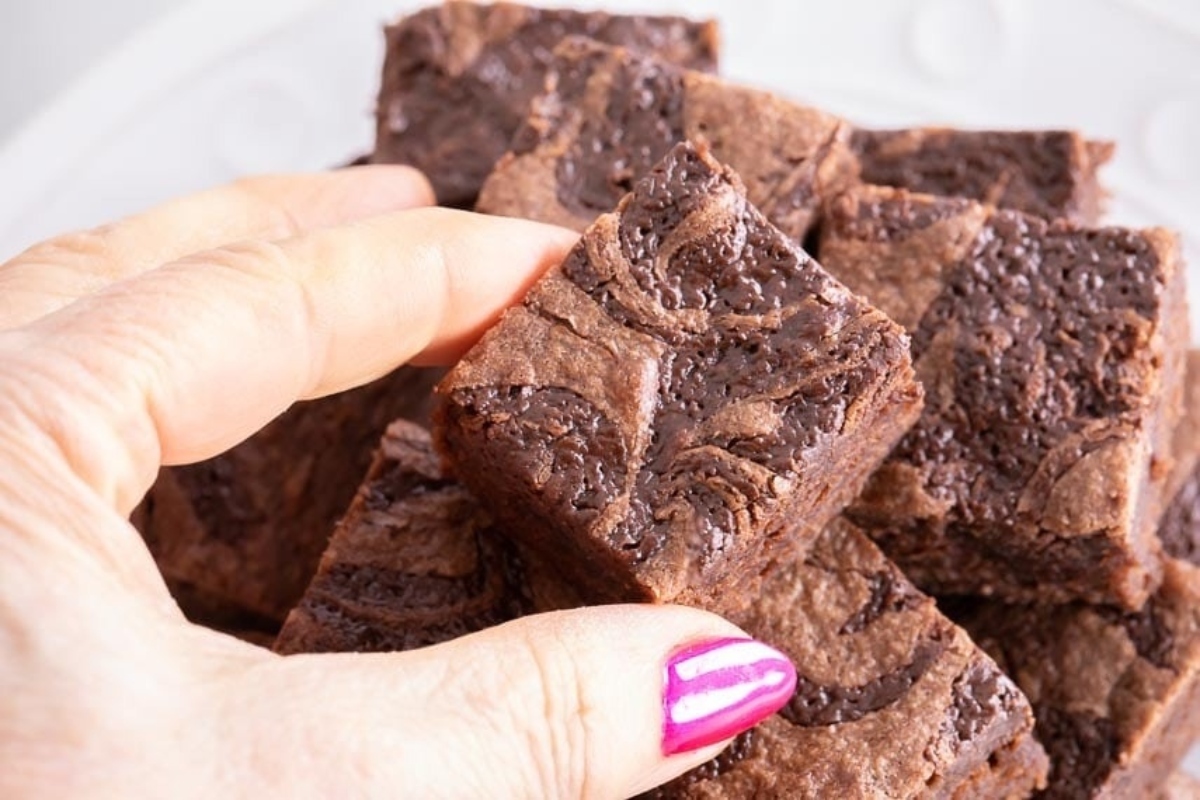You'll Go Nuts for These 25 Nutella Recipes 21 A person holding up a plate of delicious Nutella brownies.