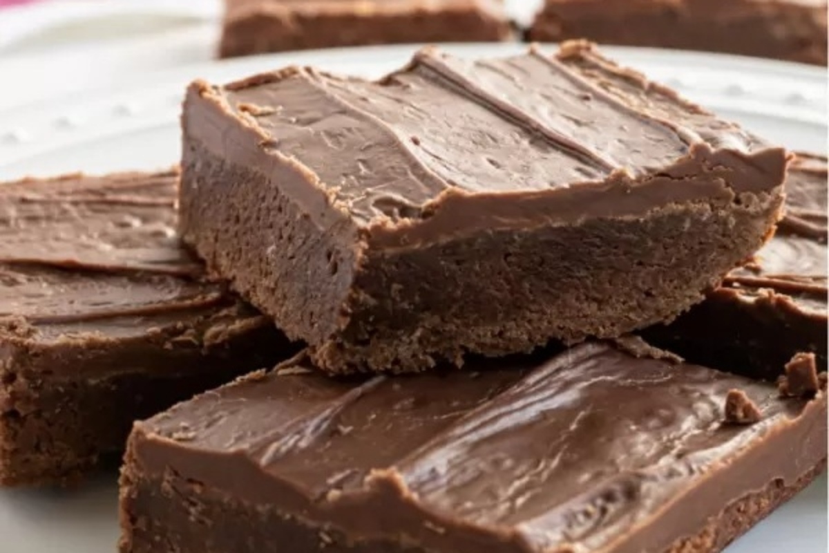 28 Brownie Recipes Chocolate Lovers Will Crave 12 A plate filled with a stack of chocolate fudge brownies, deliciously prepared according to the best brownie recipes.