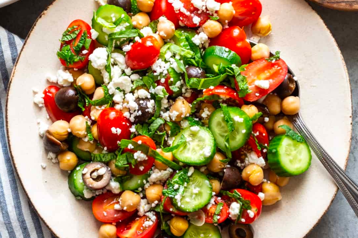 An Italian side dish of chickpea salad with tomatoes, cucumbers and feta cheese.