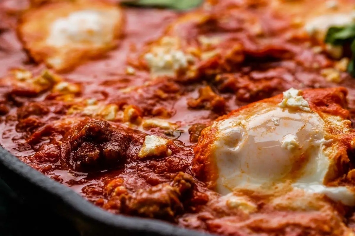 A comforting winter dinner, a skillet filled with eggs and tomato sauce.