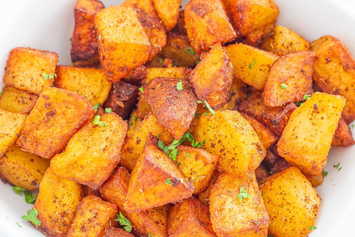 Roasted sweet potatoes in a white bowl.