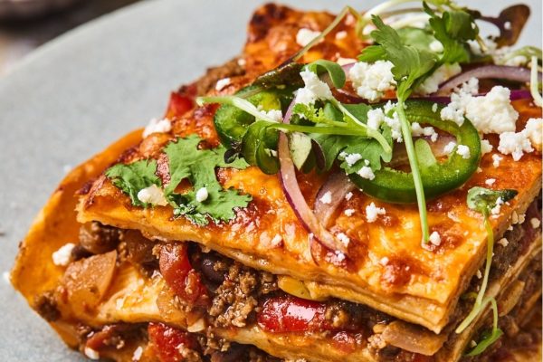 A stack of mexican lasagna on a plate.