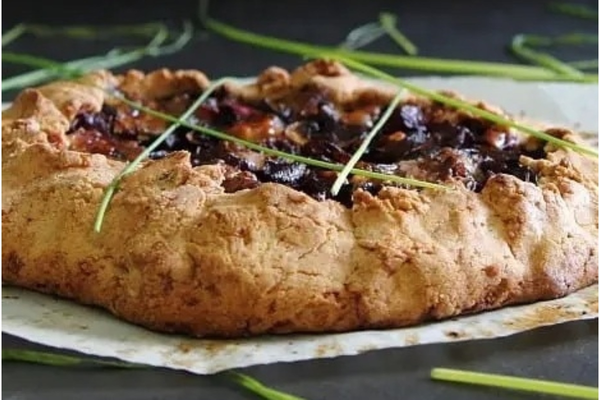 A Savoury Pie with cranberries and chives on top.