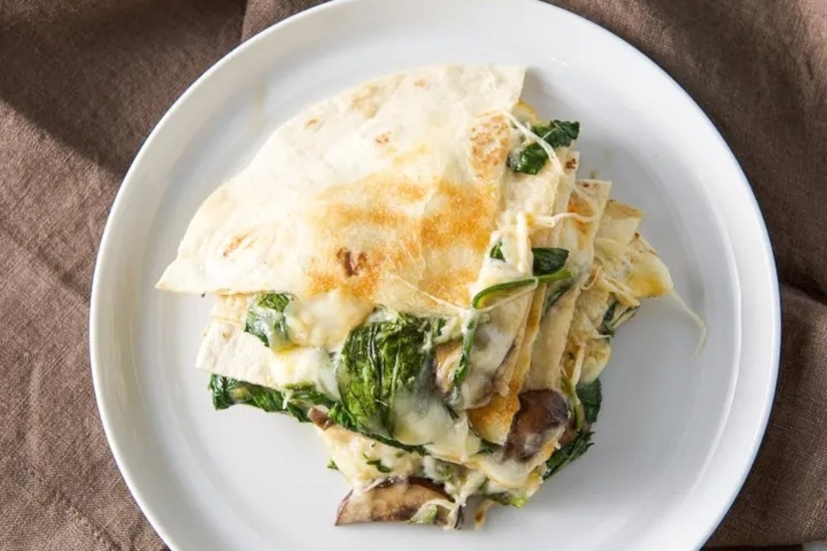 Mushroom Quesadilla plated with spinach.