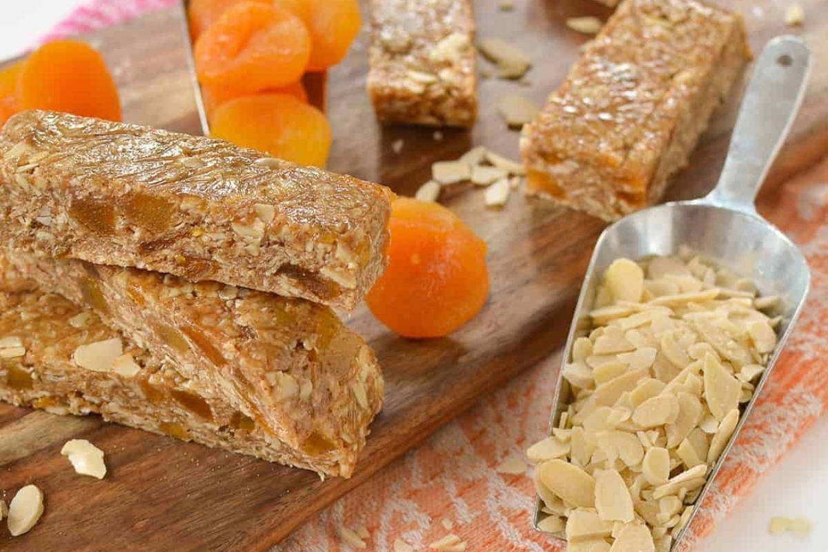 A slice of apricot granola bars on a cutting board, perfect for holiday desserts.