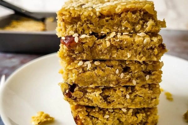 A stack of oat bars on a plate.