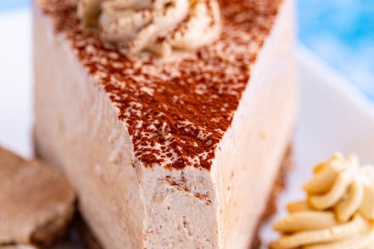 A heavenly slice of no-bake chocolate cheesecake on a pristine white plate.