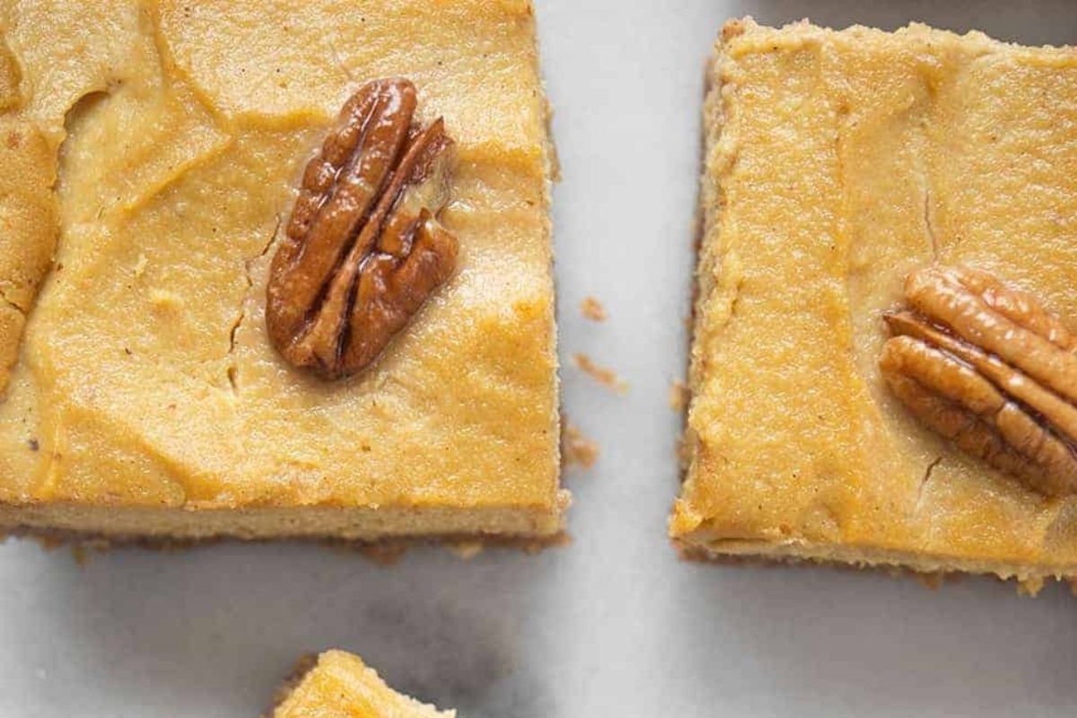 No bake pumpkin cheesecake bars with pecans, perfect for holiday desserts.