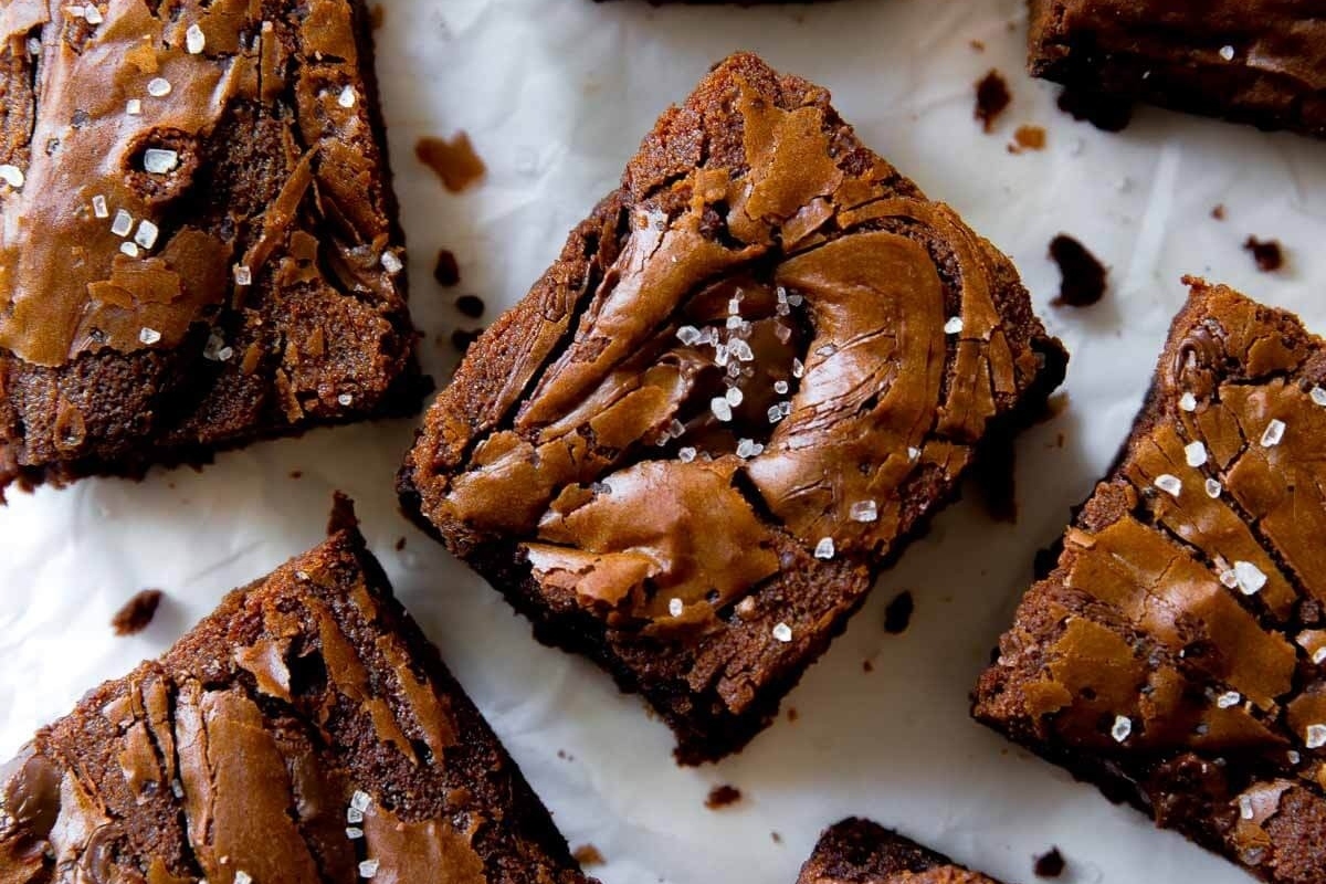 A decadent plate of chocolate brownies sprinkled with a touch of sea salt.