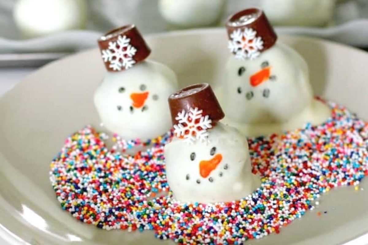 Christmas snowman truffles with Oreo sprinkles on a plate.