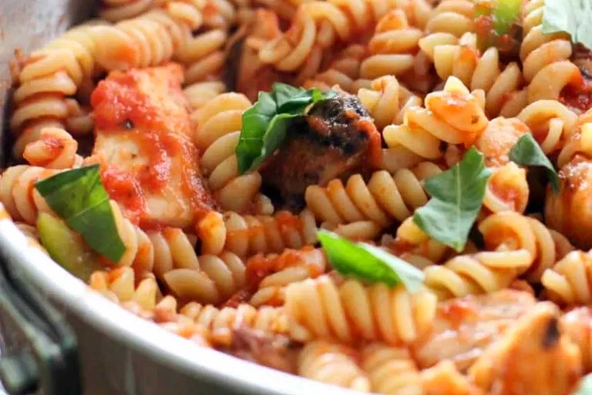 A pan full of pasta with mushrooms and tomatoes, perfect for tomato recipes.