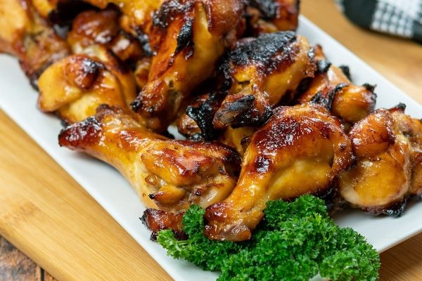 Game day BBQ chicken wings on a white plate.