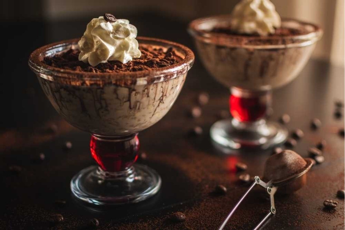 34 Italian Dessert Recipes For a Taste of La Dolce Vita 30 Two glasses of Italian chocolate pudding with whipped cream on top.