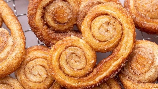 Unbelievably Easy Recipes Using Puff Pastry 15 Swedish cinnamon buns on a cooling rack.