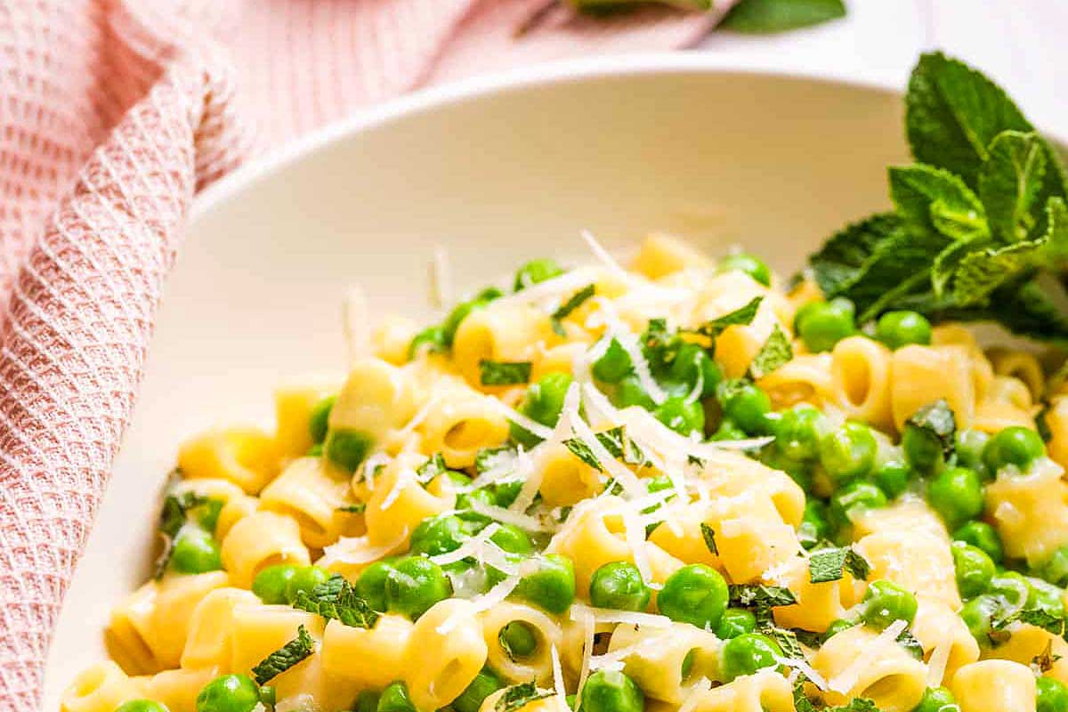 A bowl of pasta with peas and mint.