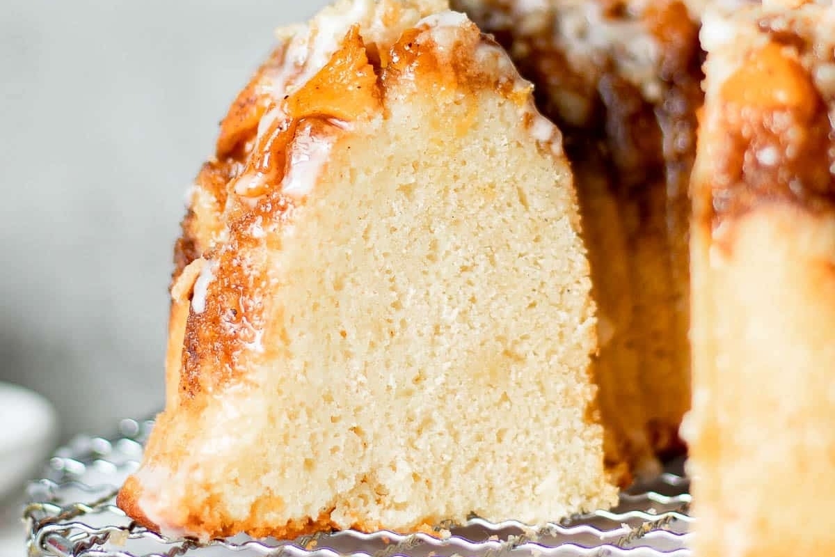 An irresistible bundt cake with a slice taken out, showcasing the moist and delectable texture of this beloved dessert.